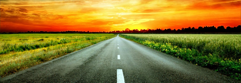 bigstock-Long-country-road-with-white-l-363936161-940x326